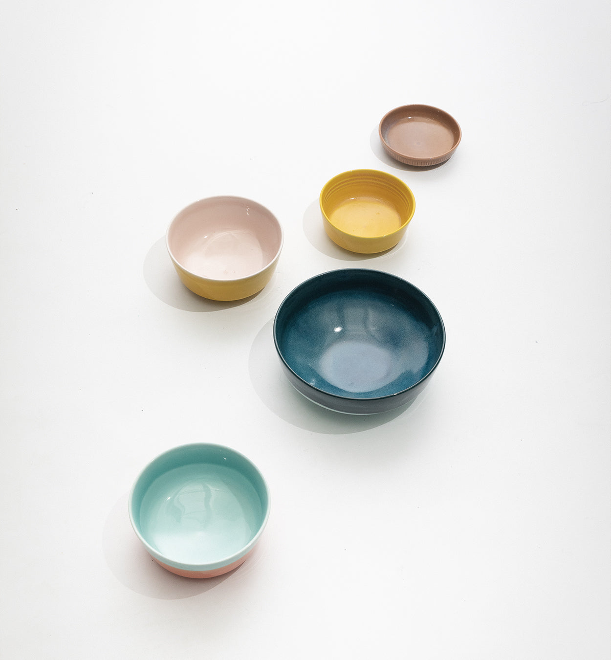 Tuntu bowls in different colors and shapes photographed on white background.